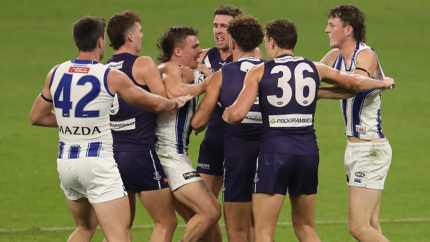 Fremantle and North players tussle.