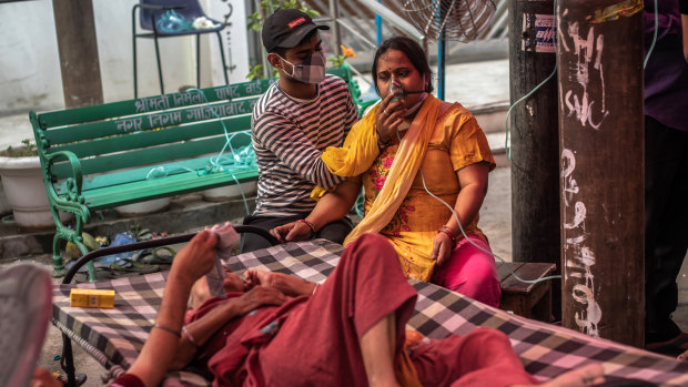 Patients suffering from Covid-19 are treated with free oxygen at a makeshift clinic in India. 