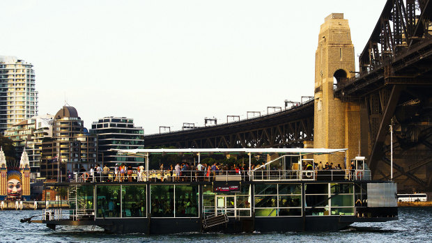 Party boats in the harbor are a time-honored Sydney tradition.  This photo shows a boat passing under the bridge in November 2014.