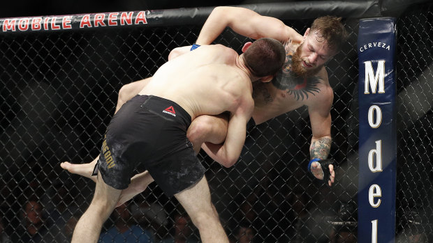 Khabib goes in for the takedown against Conor McGregor. 
