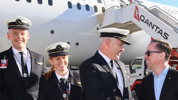 Alan Joyce, Qantas Group CEO, far right, with the flight deck crew and cabin crew at Sydney Airport celebrating after flying 19 hours and 16 minutes from New York to Sydney.