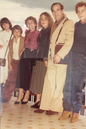 A teenage Maurice Terzini 
(at right), wearing suede boots, 
with his family in Italy in 1978.