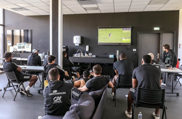 Brive players attend a video session at the club.