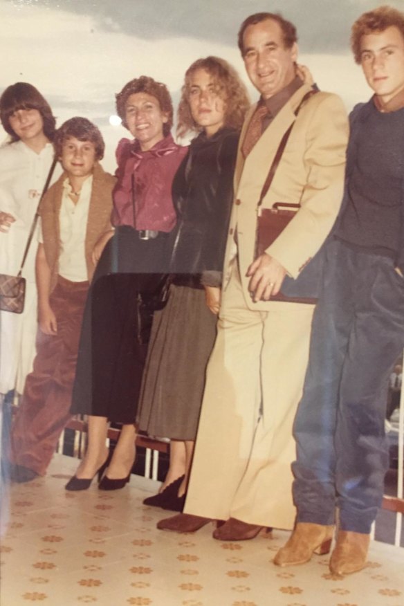 A teenage Maurice Terzini 
(at right), wearing suede boots, 
with his family in Italy in 1978.