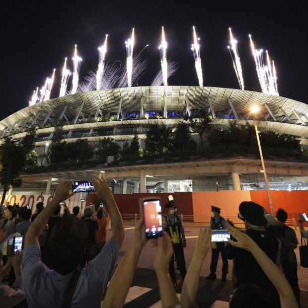 People gather outside the Tokyo National Stadium to participate in the Games closing ceremony from anyway they could, given spectators were not allowed in due to the pandemic.