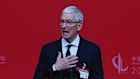 CEO Tim Cook is seen on a big screen live broadcasting his speech at the opening of the China Development Forum 2026 in Beijing. 