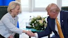 President of the European Commission Ursula von der Leyen shakes hands with US President Donald Trump.
