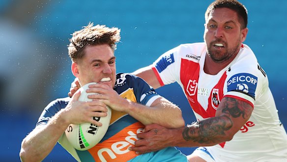 Gold Coast’s AJ Brimson tries to escape the Dragons’ Gerard Beale.