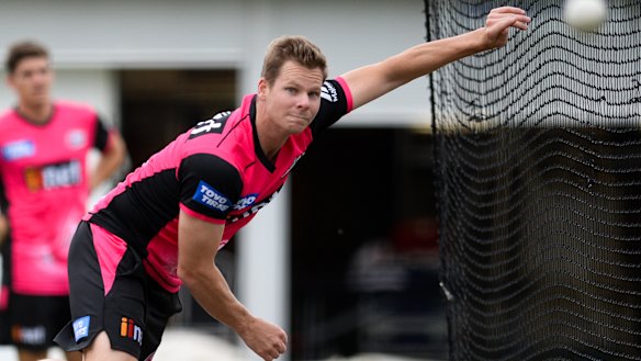 Back in the game: Steve Smith rolls his arm over in a net session for the Sydney Sixers.