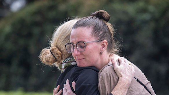 Outside the NSW Coroner’s Court at Lidcombe, Lisa Jokinen embraces her late father’s partner. 