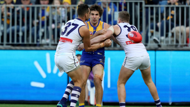 Retribution: Eagle Andrew Gaff was taken from the field after being double-teamed in a tackle by Michael Johnson and Luke Ryan of the Dockers.