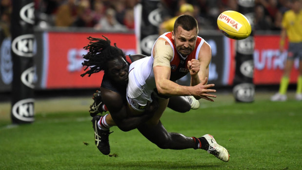 Essendon's Anthony McDonald-Tipungwuti tackles St Kilda's Jarryn Geary.