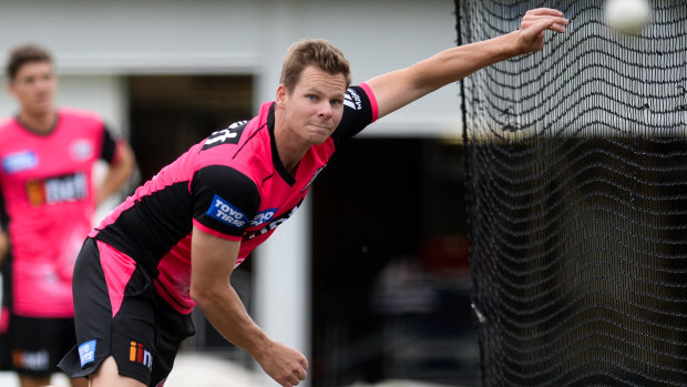 Back in the game: Steve Smith rolls his arm over in a net session for the Sydney Sixers.
