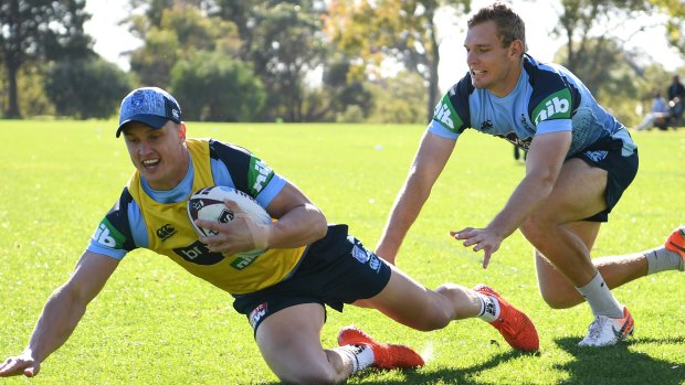 Learning the ropes: Jack Wighton goes to ground with Tom Trbojevic following at Blues training.
