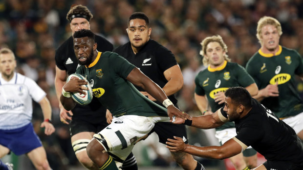 Stymied: South African captain Siya Kolisi is challenged by New Zealand's Patrick Tuipulotu, 