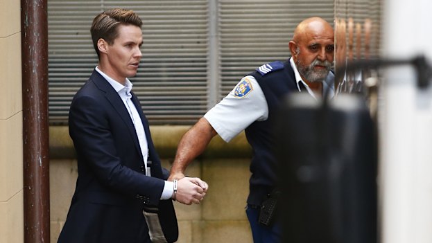 Oliver Curtis is escorted to a prison truck after being sentenced to two years in jail with a one year non-parole period in June 2016.