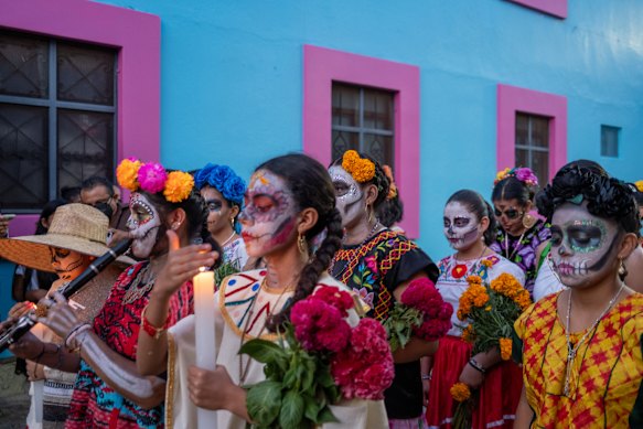 A procession on the streets of Oaxaca during Day of the Dead celebrations.