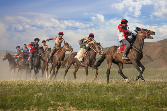 Nomad horse riders play traditional horse game of Buzkashi known also as Kokpar, in Kyrgyzstan.