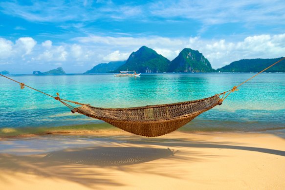A hammock with a view of Bacuit Archipelago islands, El Nido, Philippines.