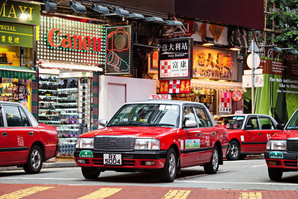 Carry cash: Hong Kong’s red taxis are everywhere.