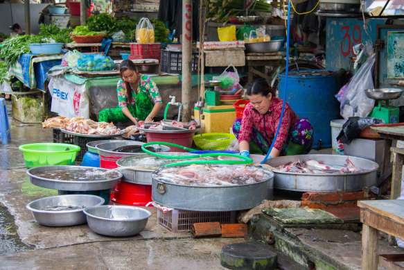 Half heaven, half horror show… vendors sell fresh seafood at the Sa Dec fish market.