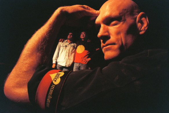 Peter Garrett sports one of the armbands. Michael Long and Hung Le are in the background.
