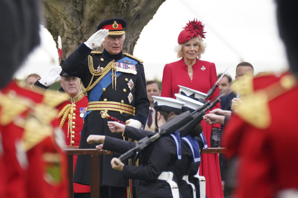 Head of a multibillion pound empire: King Charles and Camilla at a ceremony to present new standards and colours to various guards at Buckingham Palace last month.
