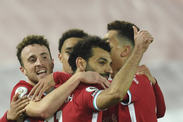 Diogo Jota (left) celebrates with Liverpool teammates after scoring the winner.