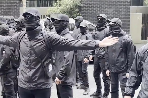Neo-Nazis dressed in black at the refugee protest in Docklands on Tuesday.