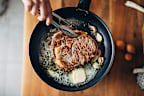 Stock image of a steak being cooked