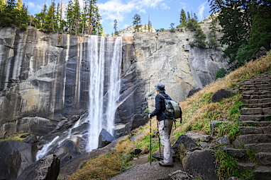 Man looking at Vernal Fall, hiking Mist Trail. Yosemite National Park. California. USA.