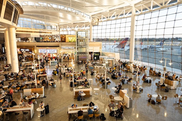 Travelers dining at the food court in the terminal of Seattle-Tacoma International Airport, Seattle, Washington, USA