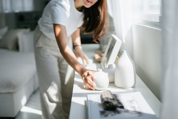 Woman tidies shelf
