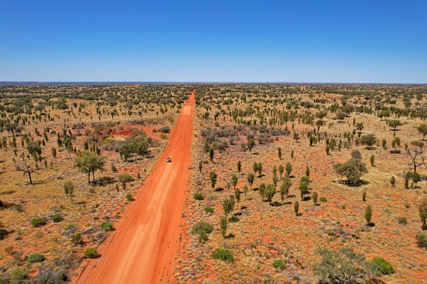 Car driving along the Vast plains in the central Australia