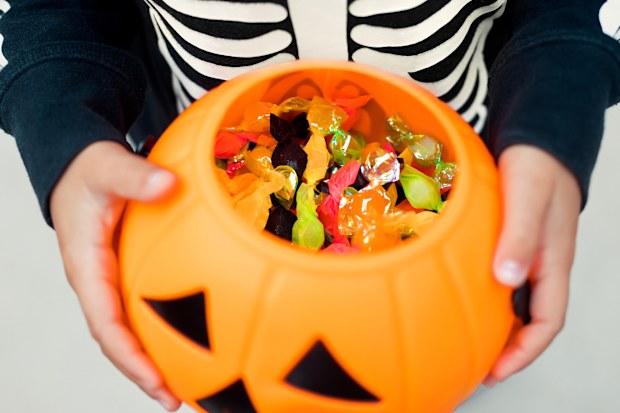 Stock image of a child holding Halloween sweets