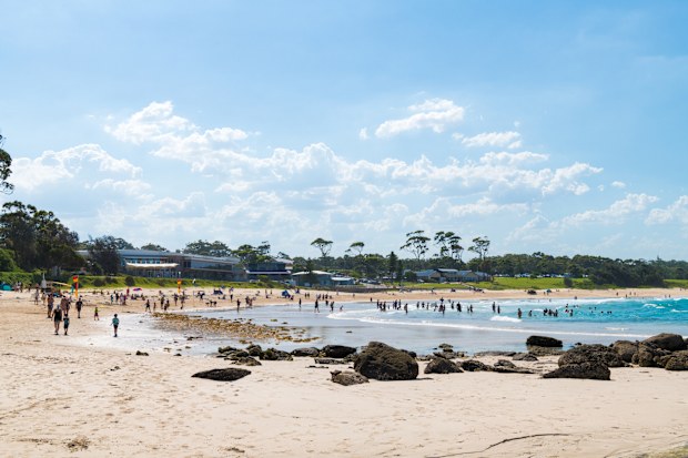 People enjoy the sunny weather at Mollymook Beach, a wonderful seaside getaway and the perfect holiday on the south coast of New South Wales, Australia.