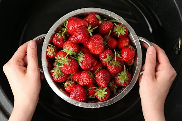 Sturdier strawberries can be washed in a colander.