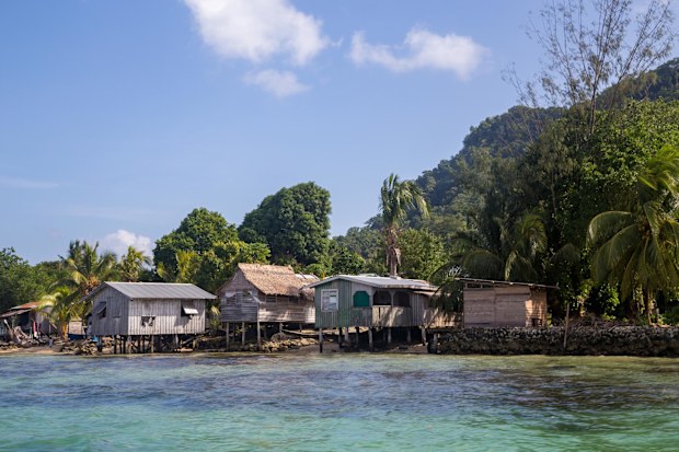 Houses along the coastline in a village on the Solomon Islands.
