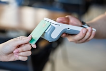 Closeup of a bankcard tapping a wireless POS reader for secure cashless transaction, ideal for fintech, retail and small business promos.