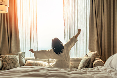 A woman stretching in bed