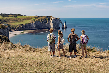Mother and three teenage kids are hiking atop the Côte d'Albâtre (Alabaster Coast) cliffs in Normandy, France.