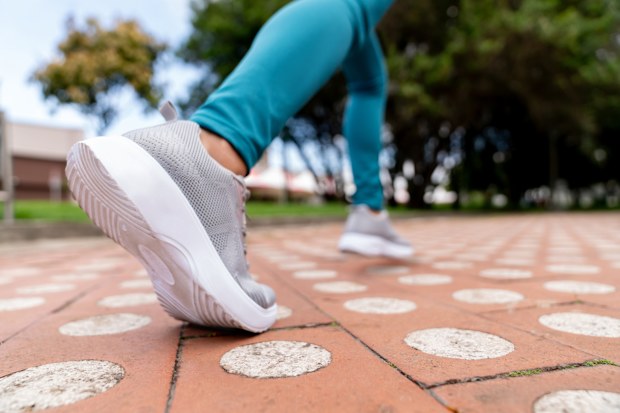 Close-up on a runner shoes running outdoors on the street