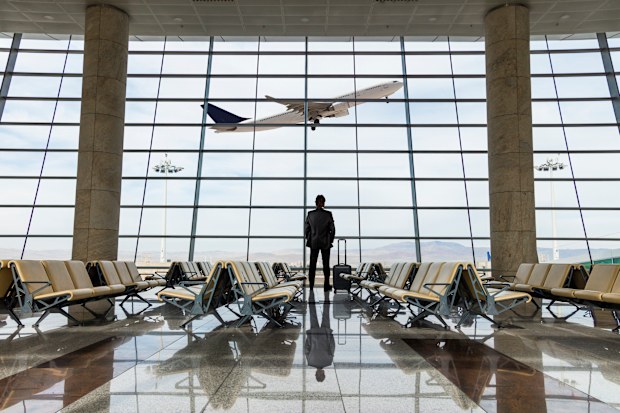 Businessman with luggage waiting in the airport