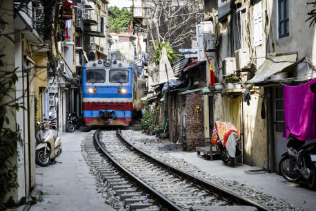 The Lotus Express passes through the astonishingly narrow Train Street.