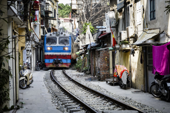 The Lotus Express passes through the astonishingly narrow Train Street.