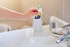 Toothbrush holders should be cleaned as part of a regular bathroom cleaning routine.