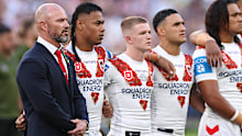 Dean Young stands with Dragons players on Anzac Day.