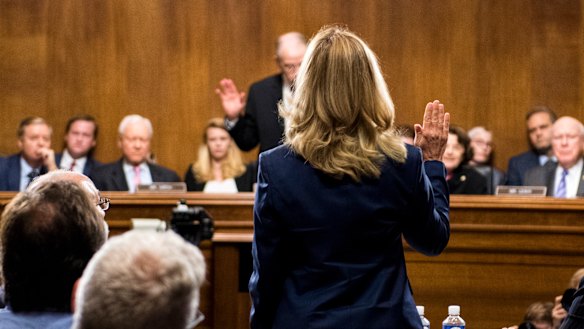 Dr Ford is sworn before giving testimony before Republican and Democrat senators.