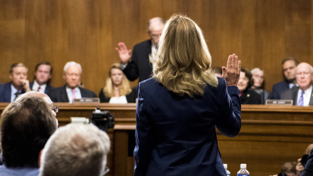Dr Ford is sworn before giving testimony before Republican and Democrat senators.