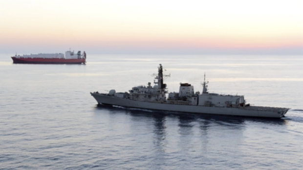 A file photo of the HMS Montrose accompanying a commercial ship through the narrow Strait of Hormuz.